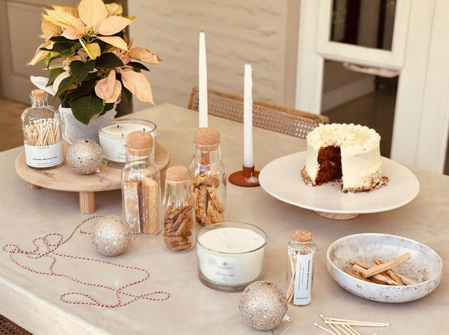 Trending Christmas Gift Ideas - a table layout of the Christmas Table in a Box Gift - candles, cake stand, long matches and biscuits