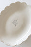 White ceramic pie dish with scalloped edge on a white background