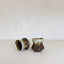 Two ceramic cups with textured surfaces on a white background