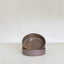 Two brown ceramic bowls stacked on a white surface with a white background