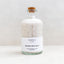 Bottle of organic bath salts with a cork lid on a white background