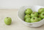 Trend{ING}s Drunken Stone Salad Bowl in Stone finish; Viewed as a close up with green apples inside