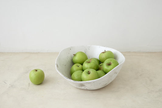 Trend{ING}s Drunken Stone Salad Bowl in Stone finish; Viewed further away with green apples inside