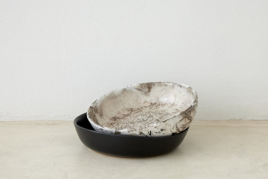 Trend{ING}s Wren Stone Breakfast Bowls stacked in Speckled Grey & White Stone on top of Coal Black
