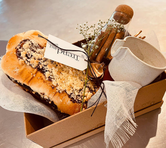 Take your time out Teachers Gift Box, featuring featuring a combination of fresh babka, cinnamon quills in a Nordic jar, and a stylish ceramic milk jug wrapped in a mocha linen bread cover.