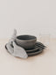 Trend{ING}s Cement Crockery Set in Grey Cement colour stacked on top of each other