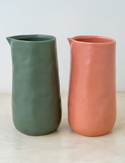 Trend-ing's ceramic stone handless jugs for juice, water or fresh cut flowers. Flint grey and coral pink colour options.