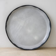 Trend{ING}s elegant XL Acacia flat ceramic platter.  Head on view of the platter with a dark grey rim