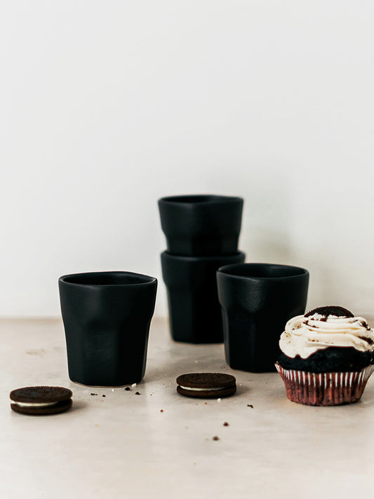 Trend-ings Espresso Ceramic Stone Cup Set in matt black, with oreos and an oreo cupcake beside it