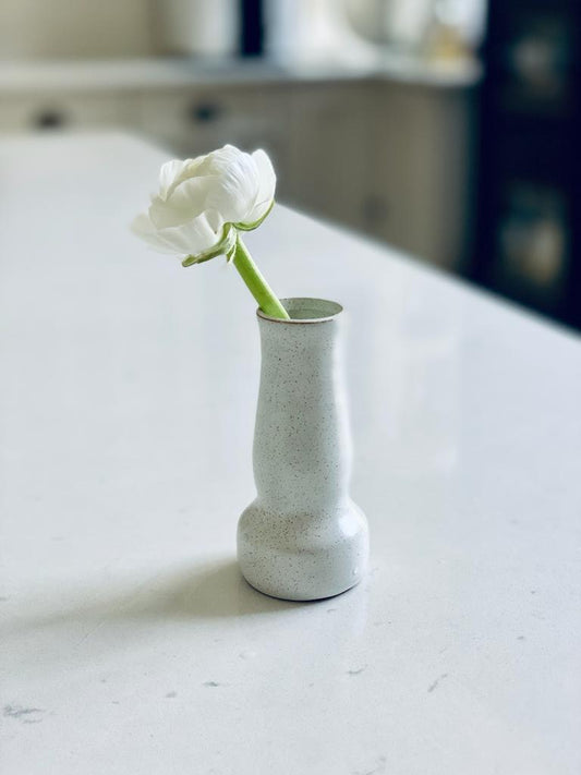 Trend{ING}s Ceramic Bud Vase with white flower inside it