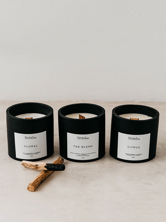 Trend-ings black wooden wick candles in various scents, Floral, The Blend & Citrus with palo santo sticks beside them