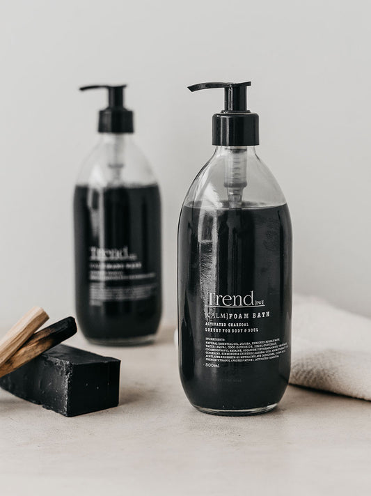 Trend-ings Activated charcoal foam bubble bath with a hand towel and palo santo sticks next to it