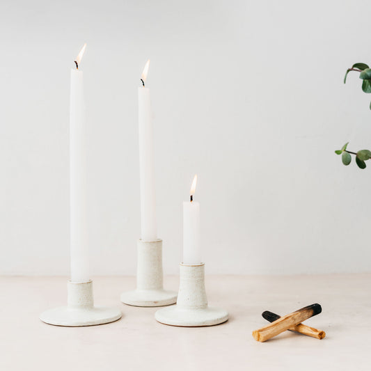 Trend{ING}s Stone matte ceramic candle holders - all 3 sizes standing together with a lit candle inside each