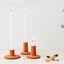 Trend{ING}s Natural terracotta ceramic candle holder - all 3 sizes standing together with lit candles inside them