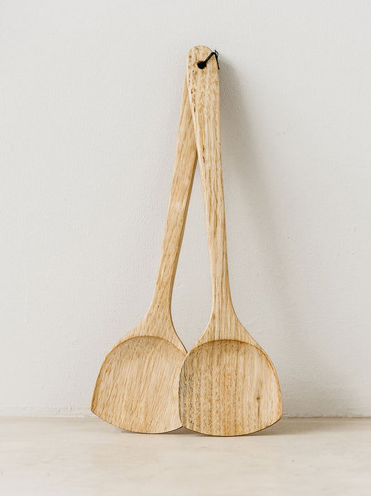 Trend-ings Walnut Wood Salad Servers standing upright against a wall