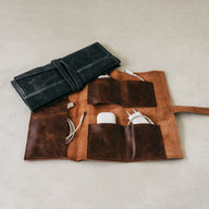 Trend-ings Leather cable organizer with iphone adapters and cables inside.