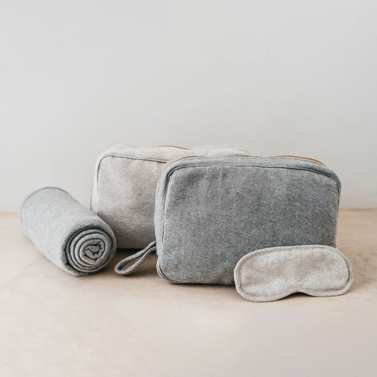 Trend-ings Cotton Travel Bag Kit in linen colour and light grey, with a small blanket and eye mask next to it