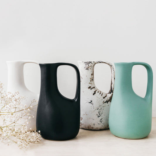 Trend-ings Stone Abstract Jug in Coal, Speckled, Smoke & Pea colours with some jibb next to them