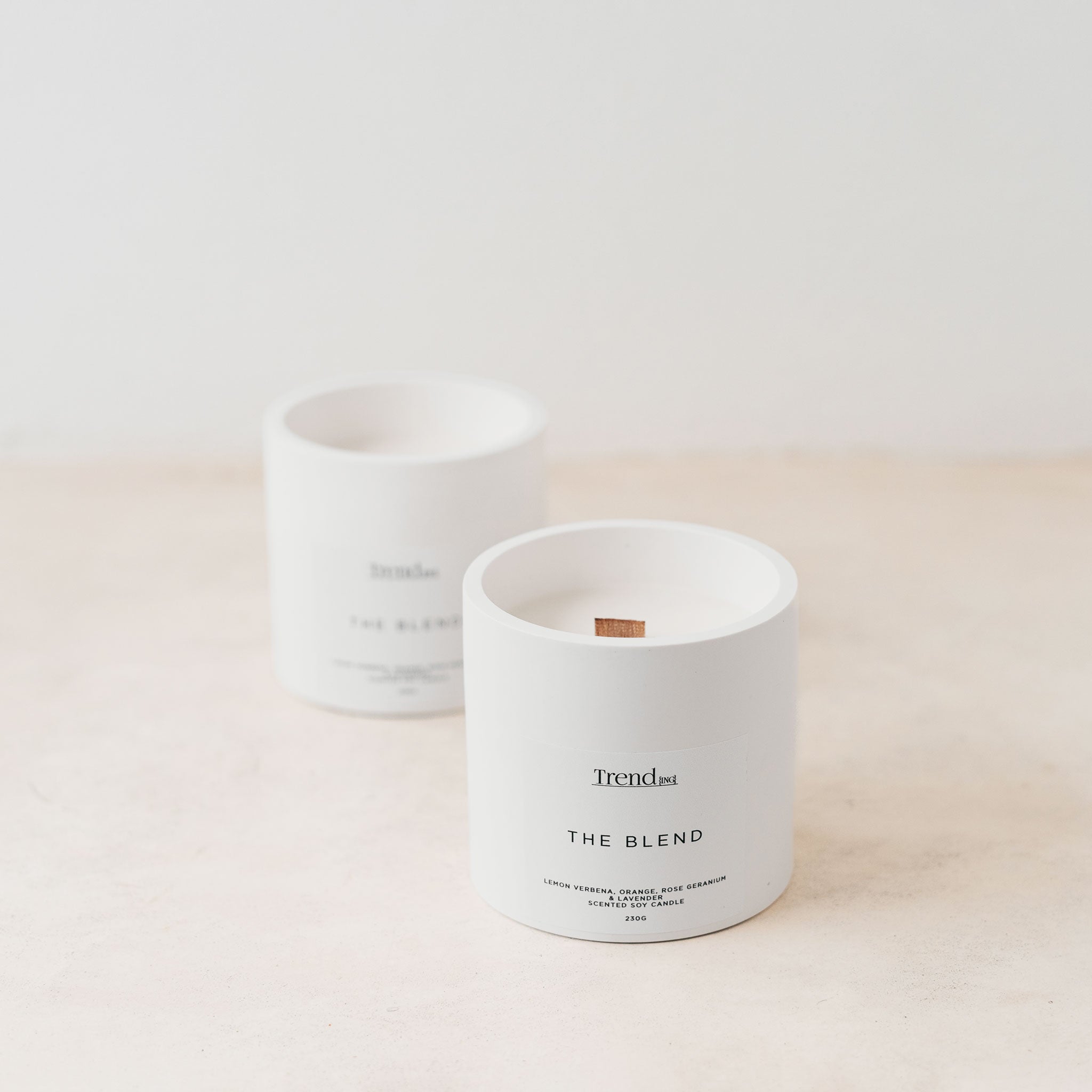 Trend{ING}s white wooden wick candle; 2 candles next to each other with the Trend{ING} branding