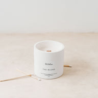 Trend{ING}s white wooden wick candle on its own with some luxury long matches with white ends