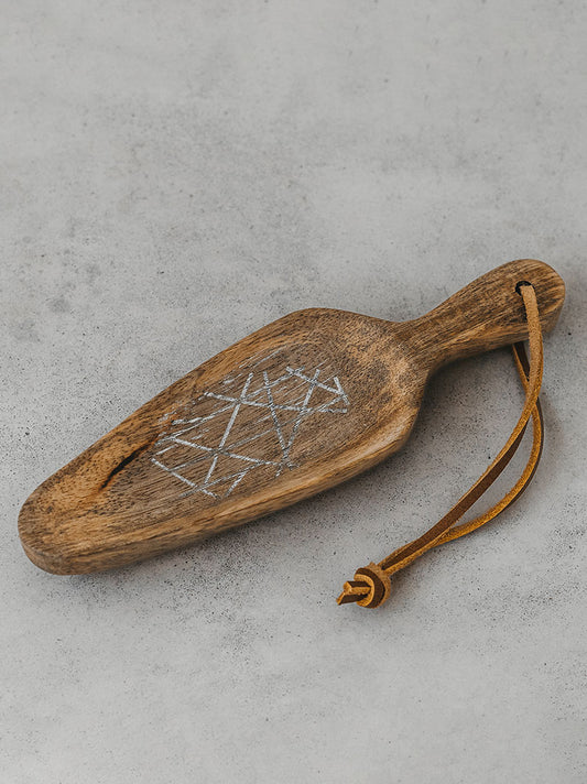Trend-ings wooden scoop with leather chord attached to the handle