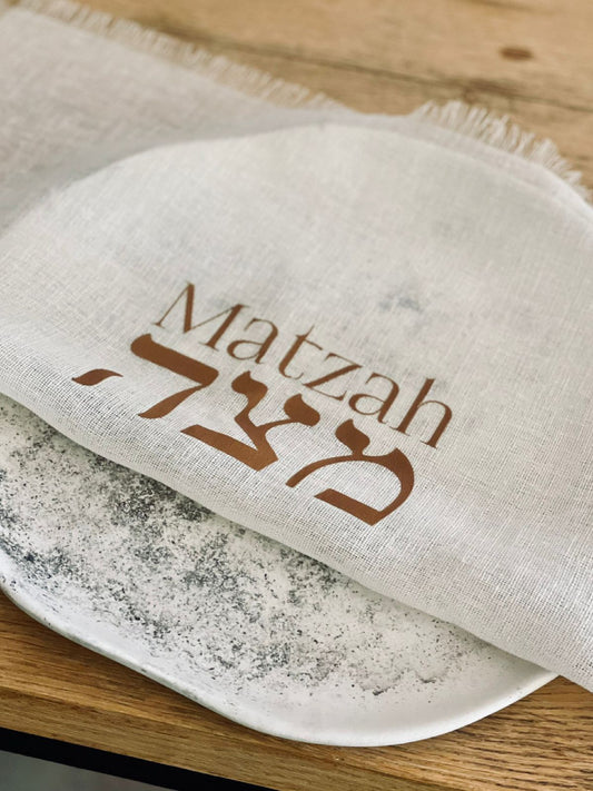 Trend{ING}s Linen Matzah Cover with Matzah writing on it